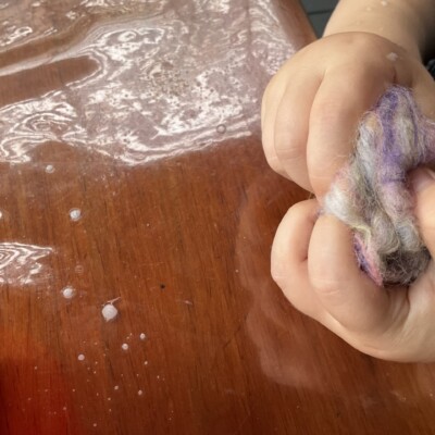 Learning to make a felt ball from wool